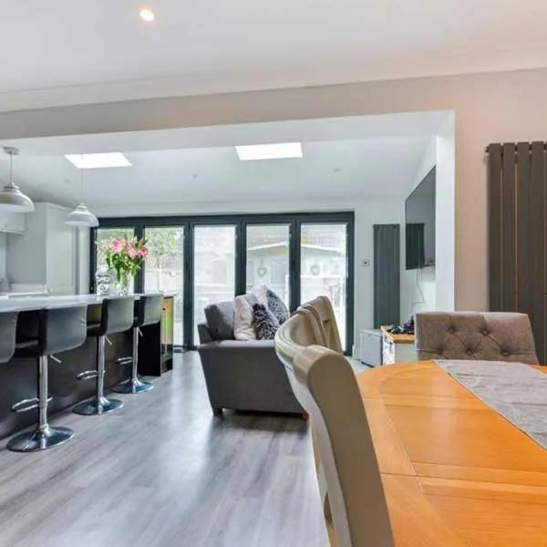 Kitchen and dining space with an island and glazed garden doors