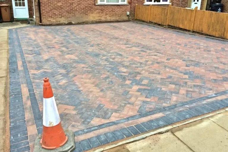 Block-paved driveway beside a garden